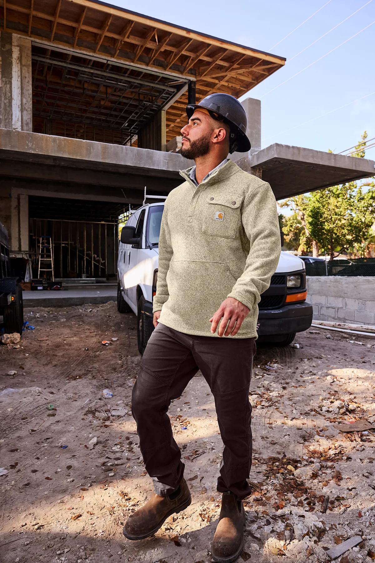Worker in a Carhartt sweater fleece shirt jacket on a construction site