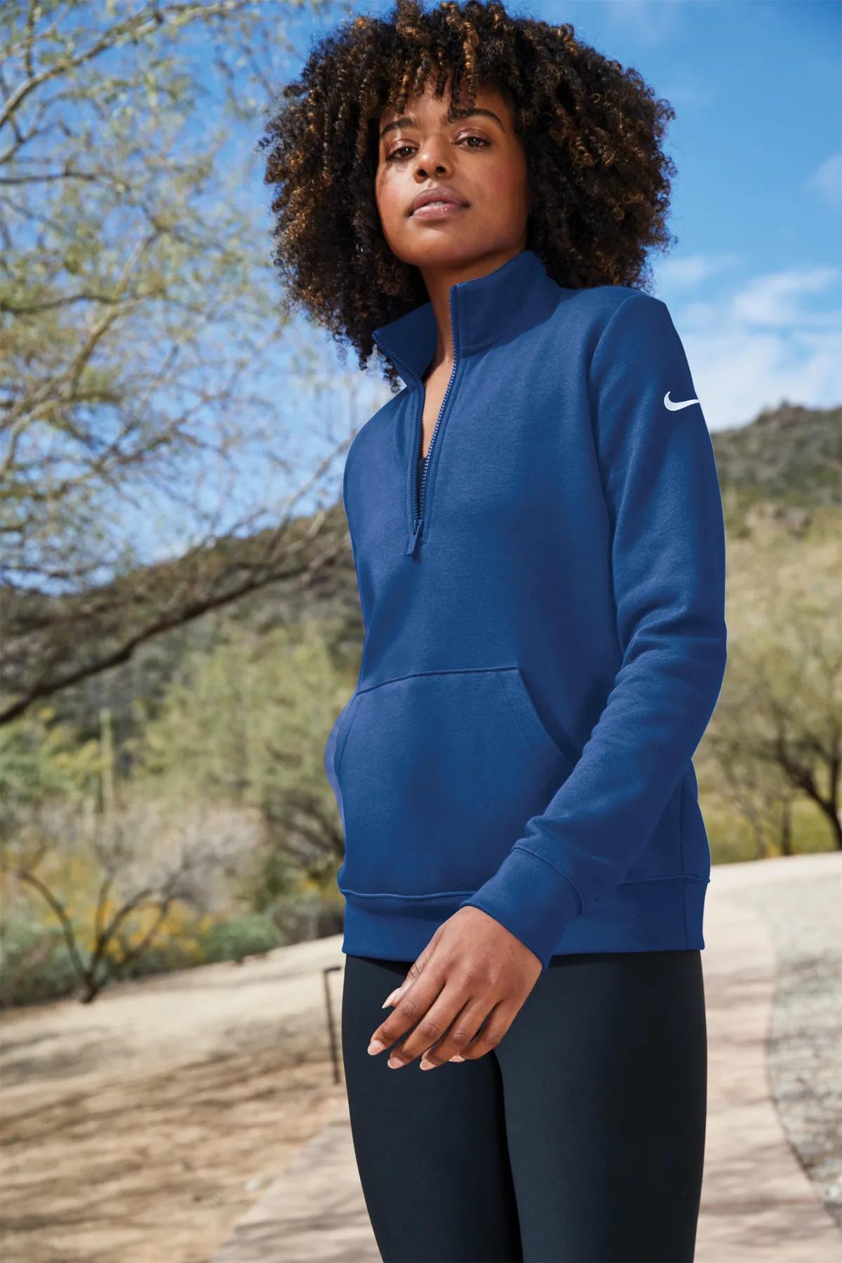 Woman wearing a royal blue Nike Club Fleece half-zip outdoors